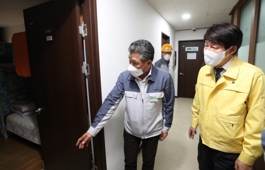 안경덕(오른쪽) 고용노동부 장관이 1일 외국인 근로자 입국 제한조치를 이달 말 완화하는 방안을 추진한다고 밝혔다. 안 장관이 1일 오후 경기도 안산시의 한 외국인 근로자 고용 사업장을 방문해 기숙사를 살펴보고 있다. <연합뉴스>
